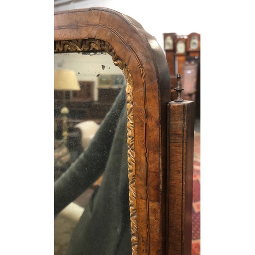 399 - A George II walnut dressing mirror, the plate within a gilt slip, over a base of three drawers on br... 