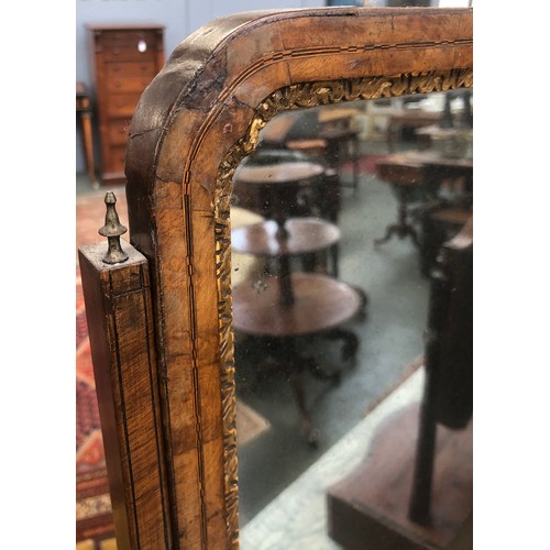 399 - A George II walnut dressing mirror, the plate within a gilt slip, over a base of three drawers on br... 