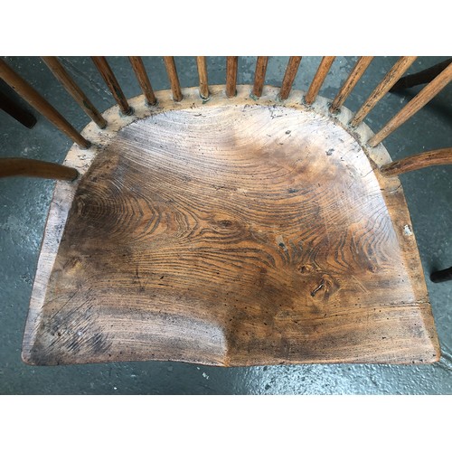 625 - A provincial elm West Country stick back Windsor chair, three part arm bow on bent supports, over a ... 