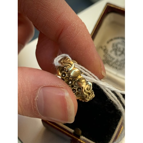 15 - A 19th century diamond cluster ring, the diamonds set in silver with a foliate engraved gold band an... 