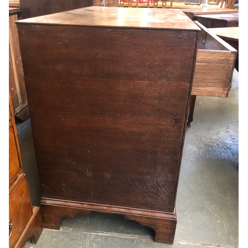 475 - An 18th century oak chest of three graduating drawers, the drawers surrounded by carcass mounted dou... 