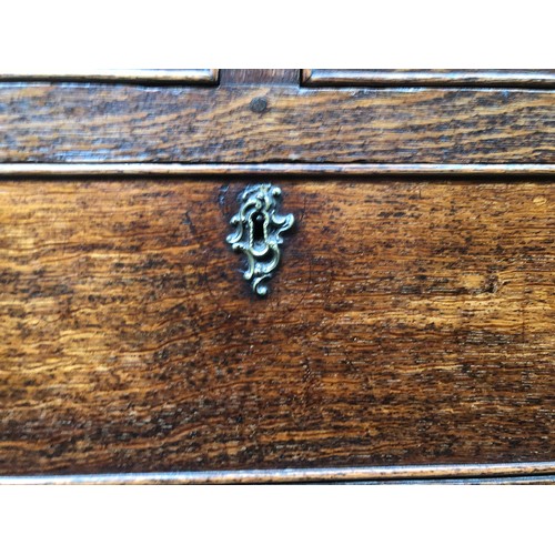 484 - A George III oak chest of drawers, the moulded top over two short and three graduating cockbeaded dr... 