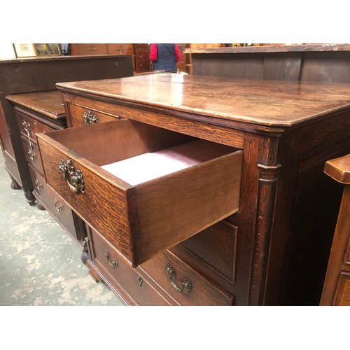 484 - A George III oak chest of drawers, the moulded top over two short and three graduating cockbeaded dr... 