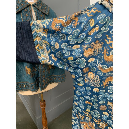 653 - A 19th century Chinese blue silk 'dragon' robe with long sleeves and horse hoof cuffs, detailed with... 