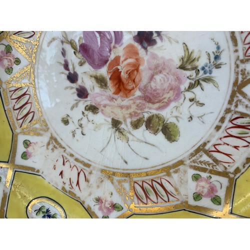 176 - A 19th century part dinner service, hand painted floral design on a yellow ground, heightened in gil... 