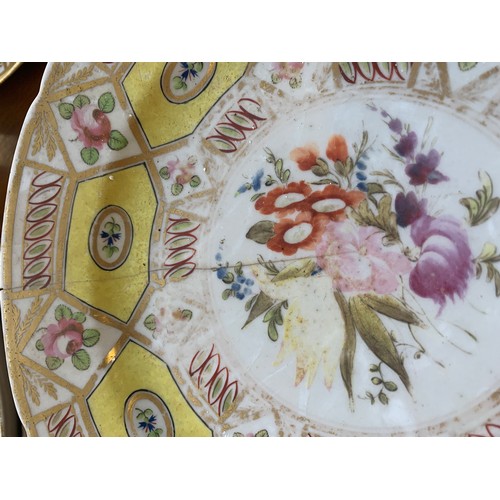 176 - A 19th century part dinner service, hand painted floral design on a yellow ground, heightened in gil... 