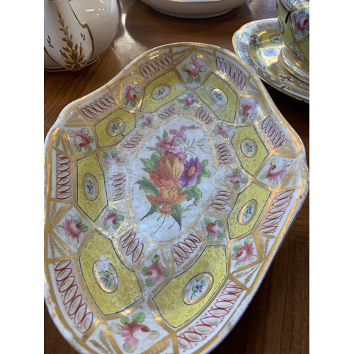 176 - A 19th century part dinner service, hand painted floral design on a yellow ground, heightened in gil... 