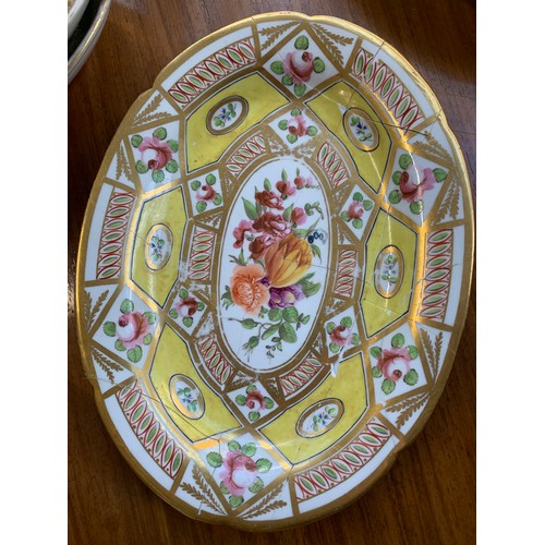 176 - A 19th century part dinner service, hand painted floral design on a yellow ground, heightened in gil... 