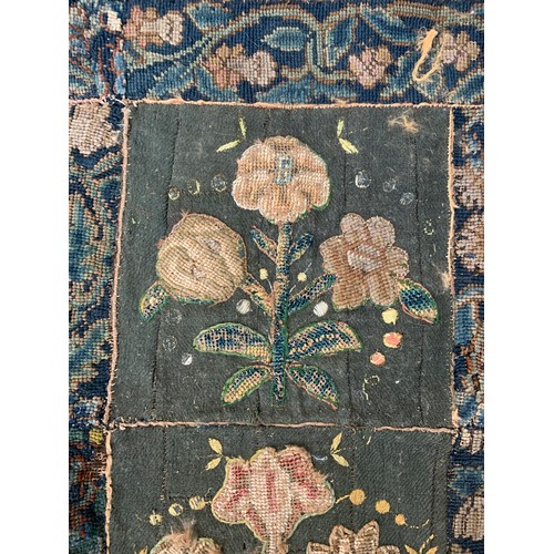 652 - A 17th century needlework tapestry table carpet, ten floral needlework slips depicting tulips, daffo... 