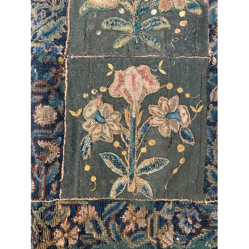 652 - A 17th century needlework tapestry table carpet, ten floral needlework slips depicting tulips, daffo... 