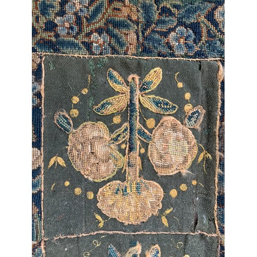 652 - A 17th century needlework tapestry table carpet, ten floral needlework slips depicting tulips, daffo... 