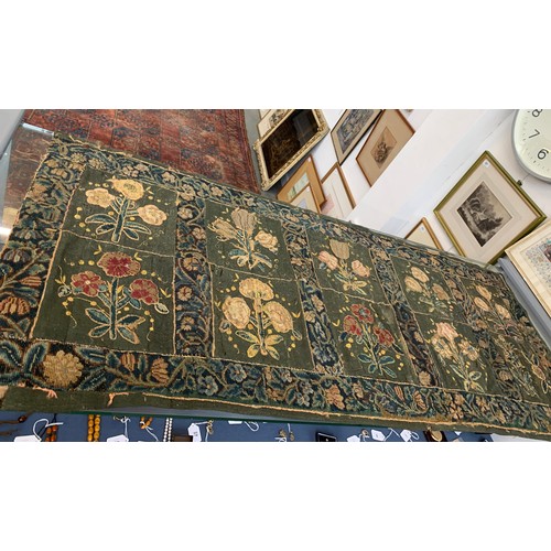 652 - A 17th century needlework tapestry table carpet, ten floral needlework slips depicting tulips, daffo... 