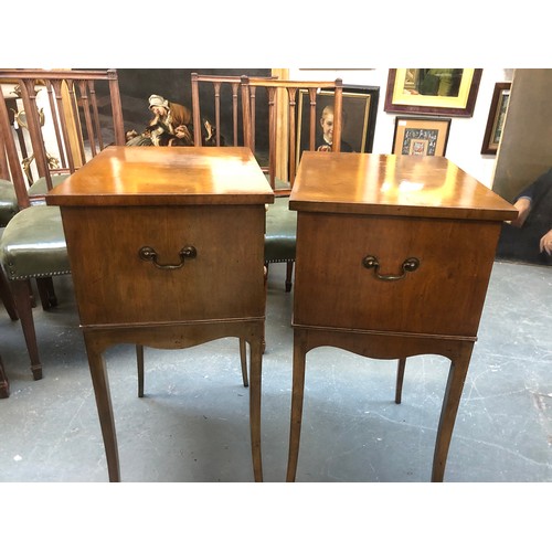 635 - A pair of mahogany cabinets, each with three drawers, with brass carry handles, raised on slender sw... 