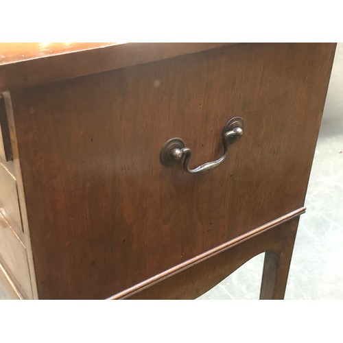 635 - A pair of mahogany cabinets, each with three drawers, with brass carry handles, raised on slender sw... 