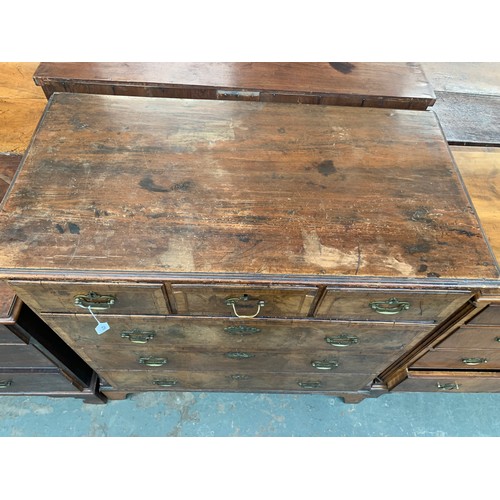 476 - A largely 18th century walnut chest of drawers, the later pine top over three short and three gradua... 