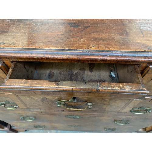 476 - A largely 18th century walnut chest of drawers, the later pine top over three short and three gradua... 