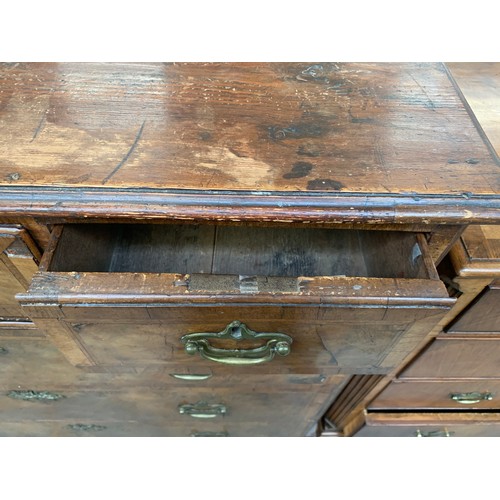 476 - A largely 18th century walnut chest of drawers, the later pine top over three short and three gradua... 