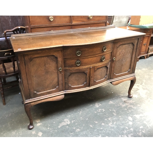 1004 - A large oak sideboard, bowfront central section flanked by two cupboard on cabriole legs, 153x63x92c... 