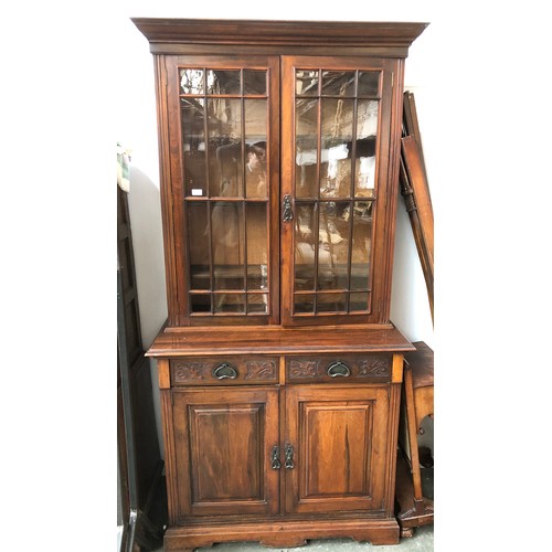 1058 - An unusual Arts and Crafts mahogany library bookcase, the top with glazed doors opening to three adj... 