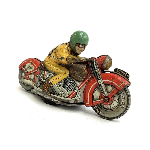 A Schuco tin plate clockwork Moto-Drill 1006 motorcycle and rider, no key, approx.  12.5cmL