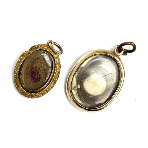 5 - A yellow metal and enamel locket (af), with split pearl crucifix decoration, glazed back, 2.3cmL; to... 