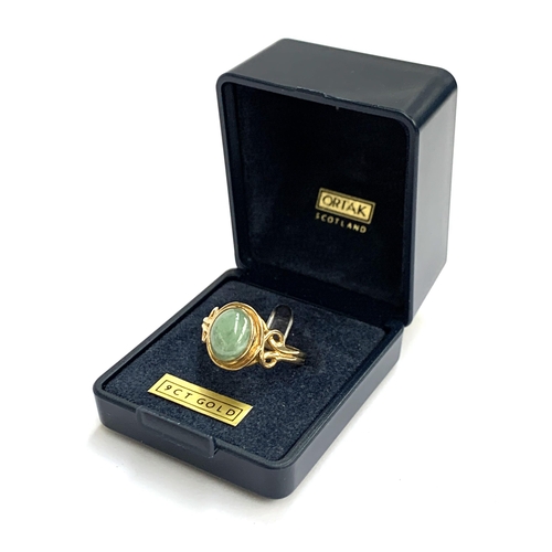 11 - A 9ct gold and jade cabochon ring with Celtic style shoulders, size N, 3.3g