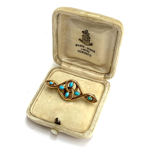 15 - An Art Nouveau 15ct gold and turquoise brooch of swirling form, possibly Murrle Bennett & Co., 4.5cm... 