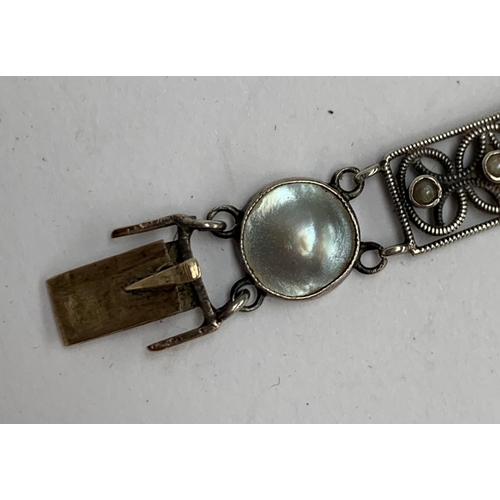 16 - A Scandinavian silver and pearl bracelet (in need of repair), openwork panels set with three seed pe... 