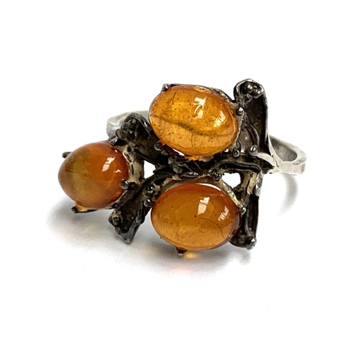 20 - A silver and amber Brutalist style ring, foreign hallmarks to outer shank; an amber and silver neckl... 