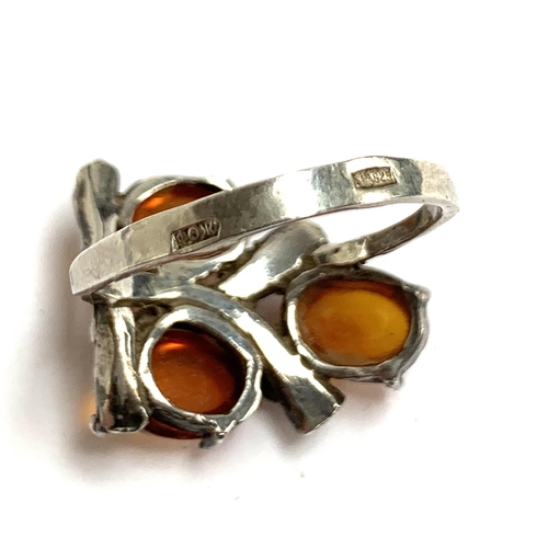 20 - A silver and amber Brutalist style ring, foreign hallmarks to outer shank; an amber and silver neckl... 