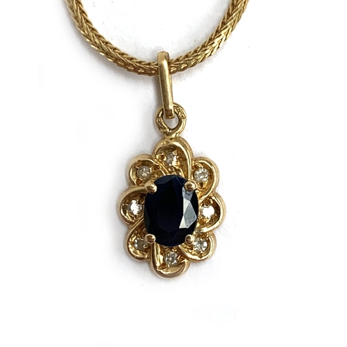 26 - An 18ct gold necklace with a floral sapphire and diamond set pendant, the chain 39cm long unclasped,... 