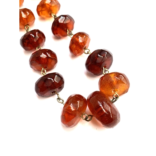 39 - A faceted amber roundel bead necklace with metal barrel clasp, 46cm long, 23.2g