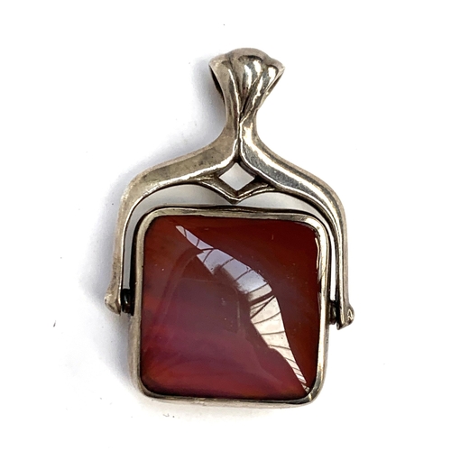 40 - A hallmarked silver spinning fob set with agate panels, 2.5cm wide