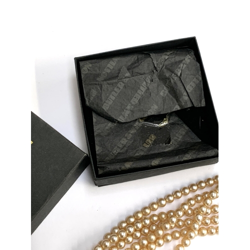 51 - A Butler & Wilson faux pearl six strand necklace, in original box bearing Harrods label, 41cmL