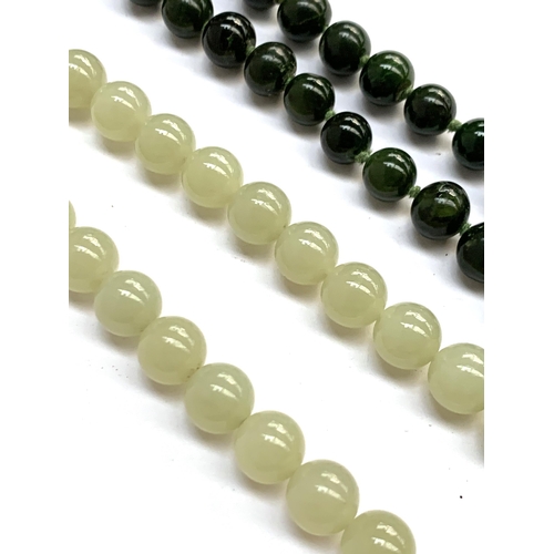 54 - A Chinese pale green jade bead necklace, each bead approx. 0.8cmD, overall 44.5cmL; together with on... 