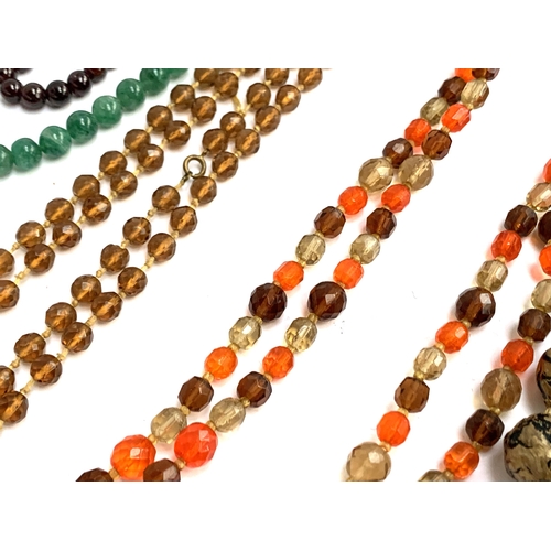 56 - A quantity of beaded necklaces to include a garnet necklace; coral and shell; West German black glas... 