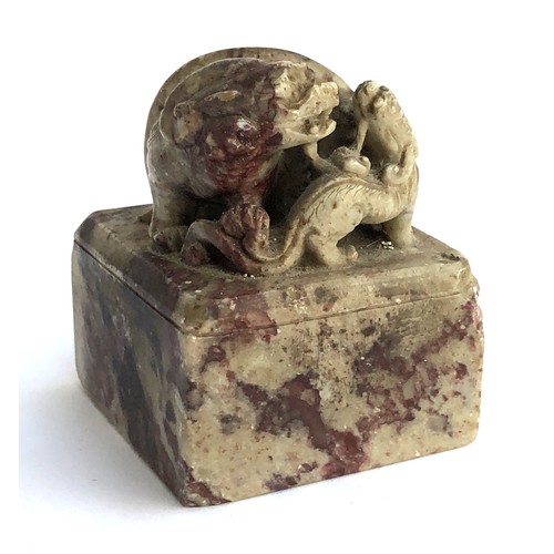 186 - A Chinese carved soapstone seal surmounted by a foo dog and puppy, red ink remnants to seal, 5.5cm w... 