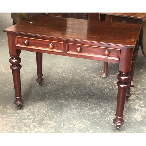 1032 - A 19th century Victorian writing table, two frieze drawers on heavy turned legs and brass casters, t... 