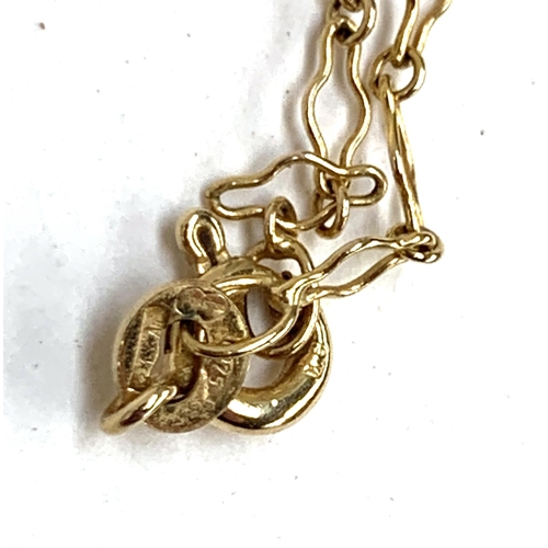 17 - A 9ct gold chain, approx. 1.8g, with a floral gilt metal pendant