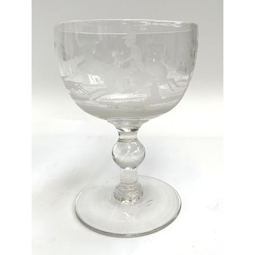 126 - A 20th century hand blown glass goblet, engraved with hunting scenes, 16.5cmH