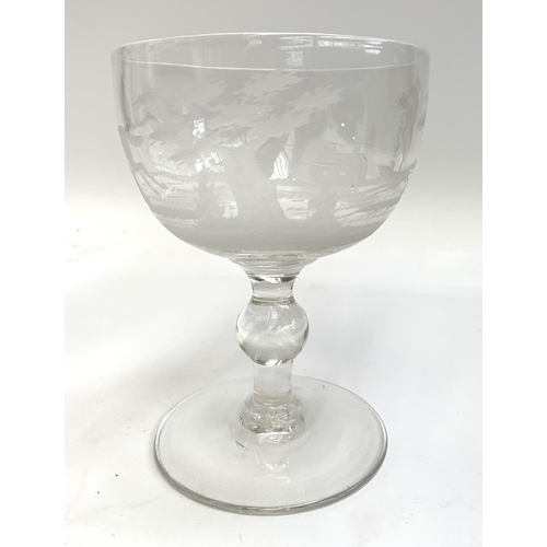 126 - A 20th century hand blown glass goblet, engraved with hunting scenes, 16.5cmH