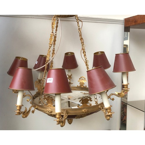 1062 - An eight arm gilt metal chandelier, each fitting on a swan form candle style sconce, with tole ware ... 