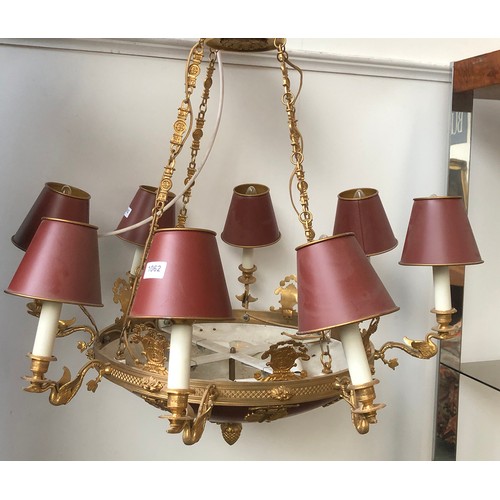 1062 - An eight arm gilt metal chandelier, each fitting on a swan form candle style sconce, with tole ware ... 