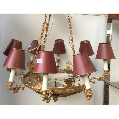 1062 - An eight arm gilt metal chandelier, each fitting on a swan form candle style sconce, with tole ware ... 