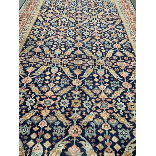 A large Persian rug, approx. 329x154cm