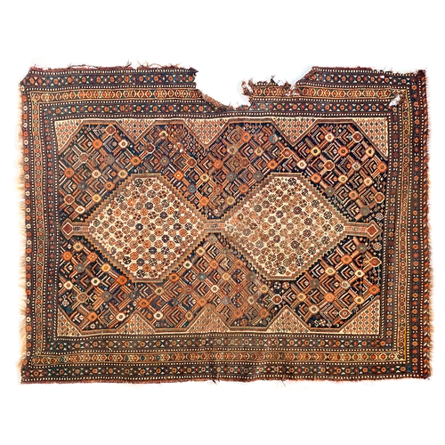 710 - A Persian rug, 20th century, with two serrated lozenges (damage), 186x141cm