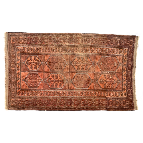 713 - A Turkeman Ersari rug, red ground with eight rectangular panels, 180x108cm