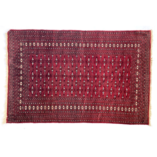 714 - A red ground Turkmen rug, 187x125cm