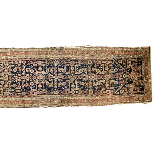 715 - A large Persian Mahal runner rug, indigo ground within a triple border, 474x114cm