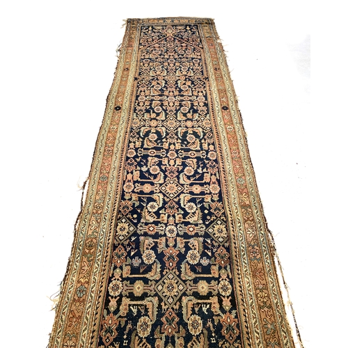 715 - A large Persian Mahal runner rug, indigo ground within a triple border, 474x114cm